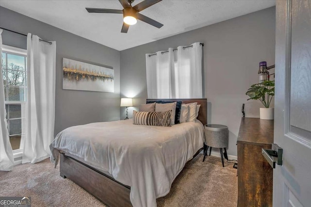 bedroom featuring ceiling fan and light colored carpet