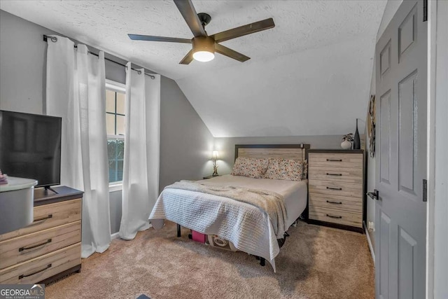 carpeted bedroom featuring lofted ceiling, ceiling fan, and a textured ceiling