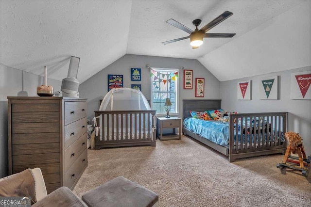 carpeted bedroom featuring lofted ceiling, ceiling fan, and a textured ceiling