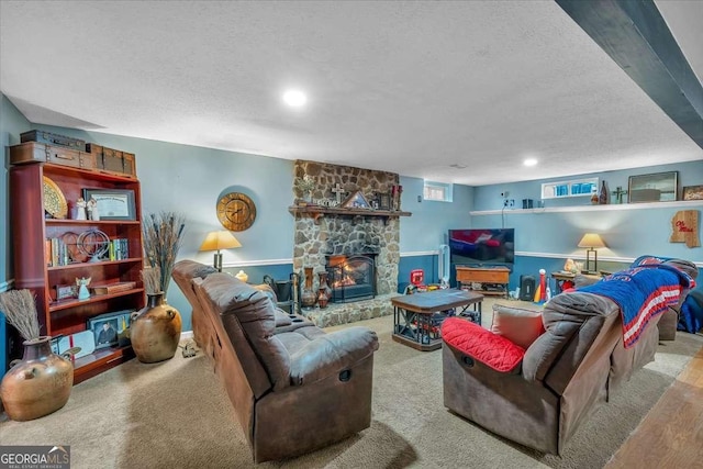 living room featuring a stone fireplace, light colored carpet, and a textured ceiling