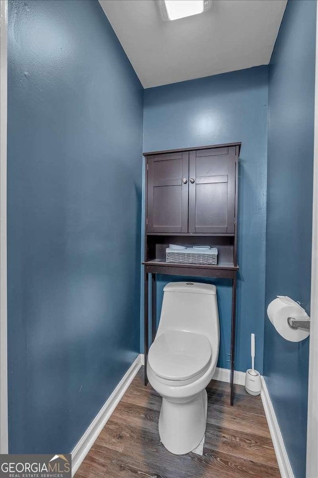 bathroom featuring hardwood / wood-style flooring and toilet