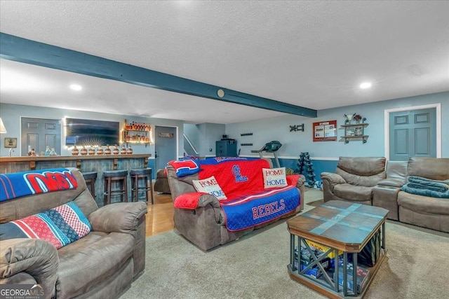 carpeted living room featuring bar, a textured ceiling, and beamed ceiling