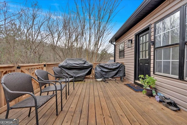 wooden terrace featuring a grill