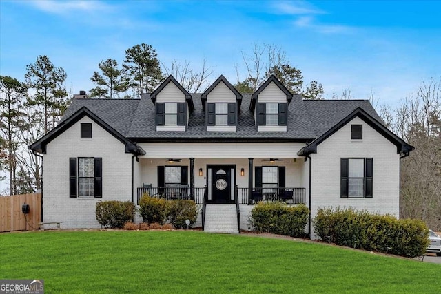 cape cod home featuring a front lawn and a porch