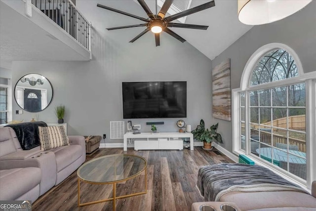 living room with ceiling fan, dark hardwood / wood-style flooring, and high vaulted ceiling