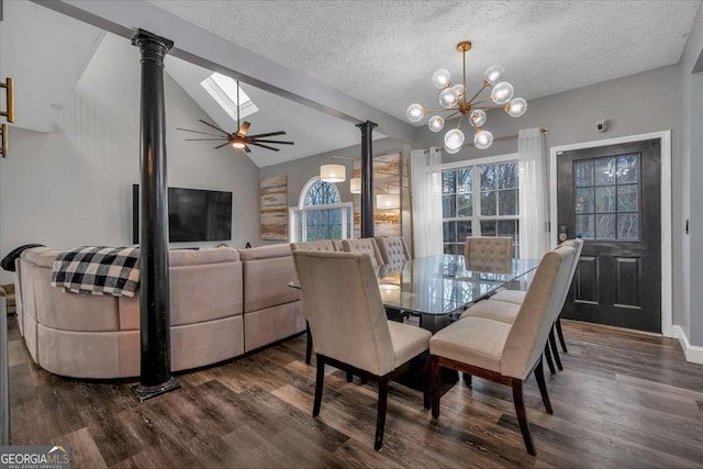 dining area featuring an inviting chandelier, decorative columns, dark hardwood / wood-style floors, vaulted ceiling with skylight, and a textured ceiling