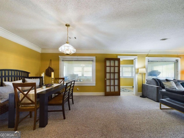 dining room featuring crown molding, carpet floors, and a textured ceiling