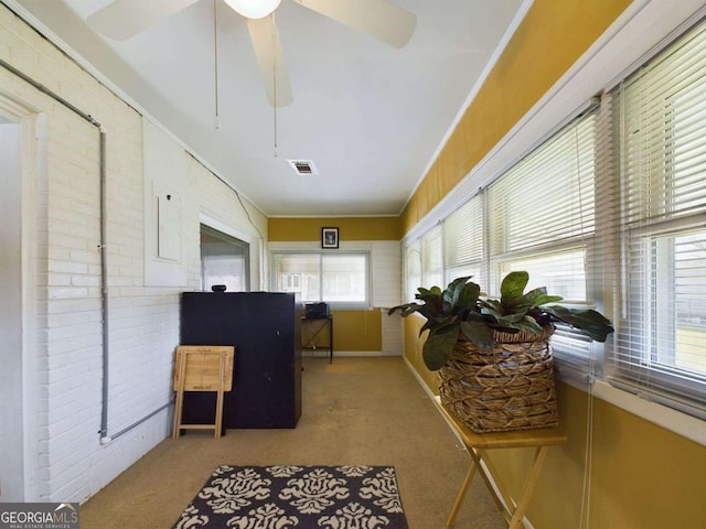 sunroom featuring ceiling fan