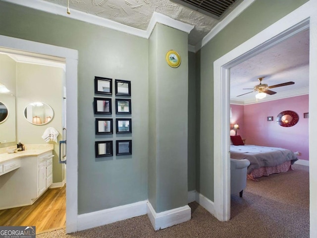 interior space with light colored carpet, ornamental molding, and a textured ceiling