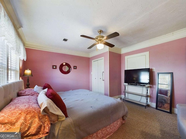 carpeted bedroom featuring crown molding, a textured ceiling, and ceiling fan