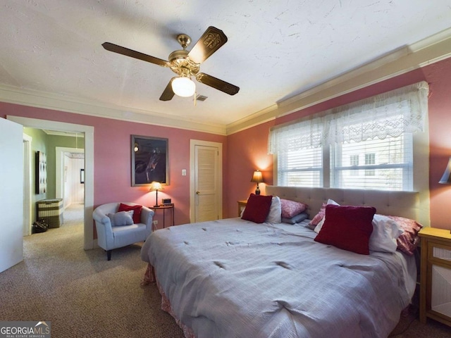 bedroom featuring ceiling fan, carpet floors, ornamental molding, and a textured ceiling