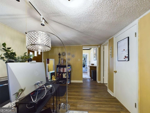 corridor featuring a textured ceiling and dark hardwood / wood-style flooring