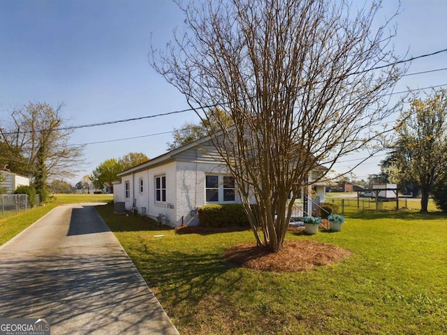 view of side of home featuring a yard