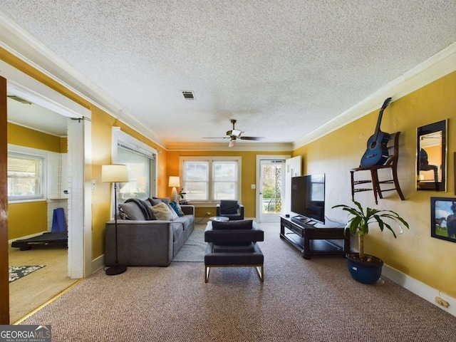 carpeted living room with ceiling fan, ornamental molding, and a textured ceiling