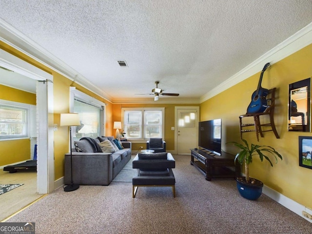 living room with plenty of natural light, ornamental molding, and carpet flooring