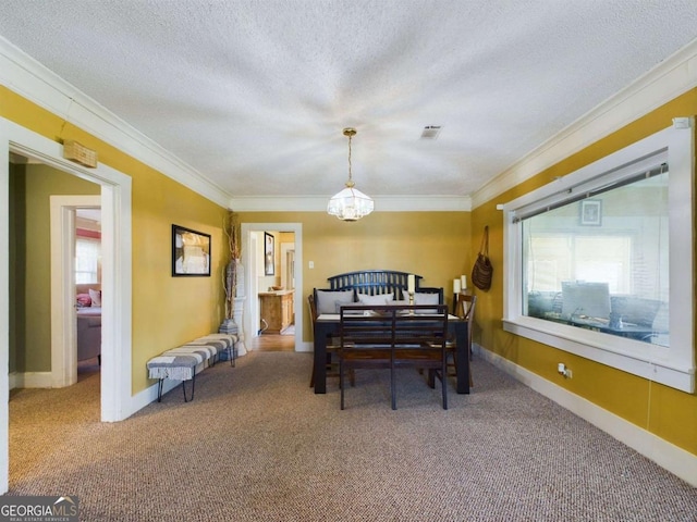 carpeted dining area with ornamental molding, a chandelier, and a textured ceiling