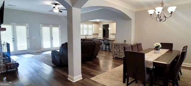 dining area featuring sink, ornamental molding, dark hardwood / wood-style floors, and ceiling fan with notable chandelier