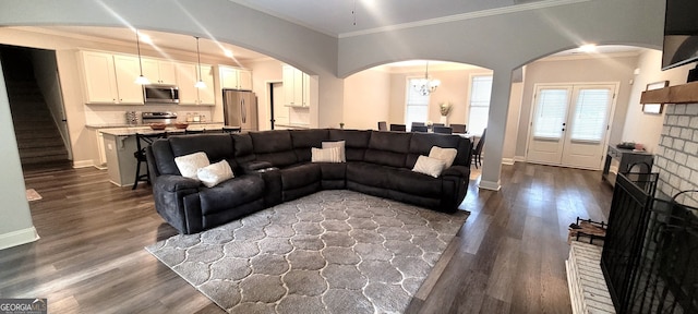 living room with crown molding and dark hardwood / wood-style flooring