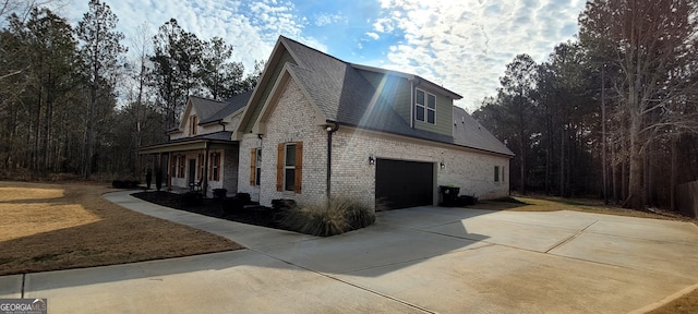 view of home's exterior featuring a garage and covered porch