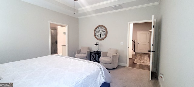 carpeted bedroom featuring crown molding and a raised ceiling