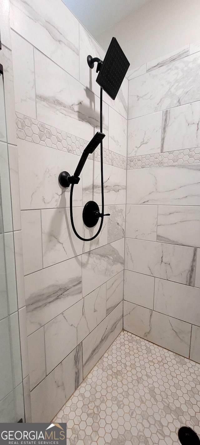 bathroom with a tile shower