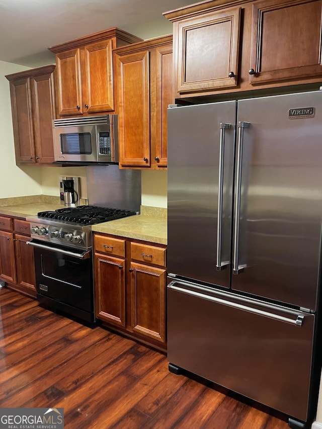 kitchen with stainless steel appliances and dark hardwood / wood-style floors