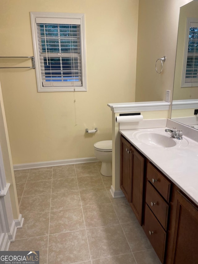 bathroom featuring tile patterned flooring, vanity, and toilet