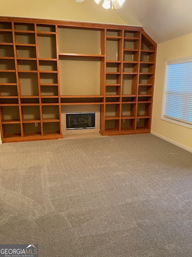 unfurnished living room with lofted ceiling and carpet