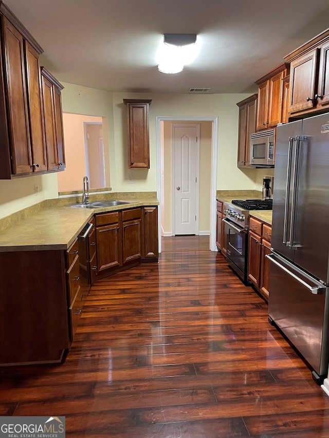 kitchen featuring sink, dark hardwood / wood-style floors, and high quality appliances