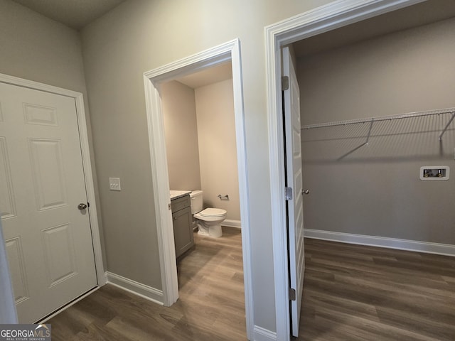 bathroom featuring vanity, hardwood / wood-style floors, and toilet