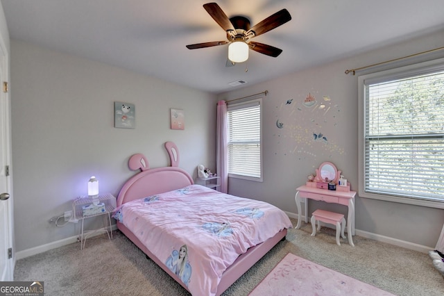 bedroom featuring multiple windows, light colored carpet, and ceiling fan