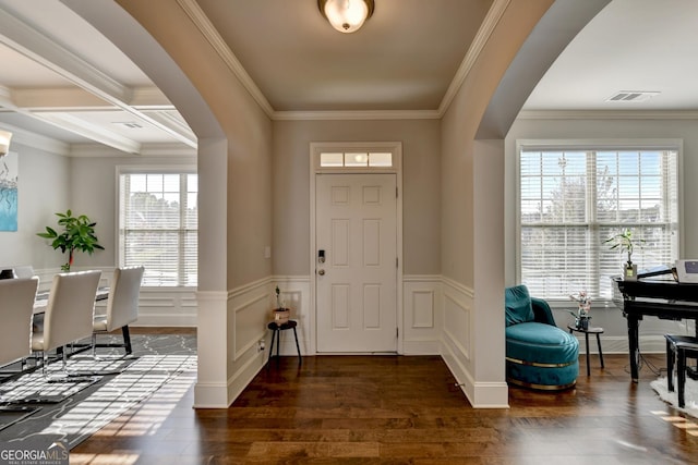 foyer with beamed ceiling, crown molding, and dark hardwood / wood-style floors