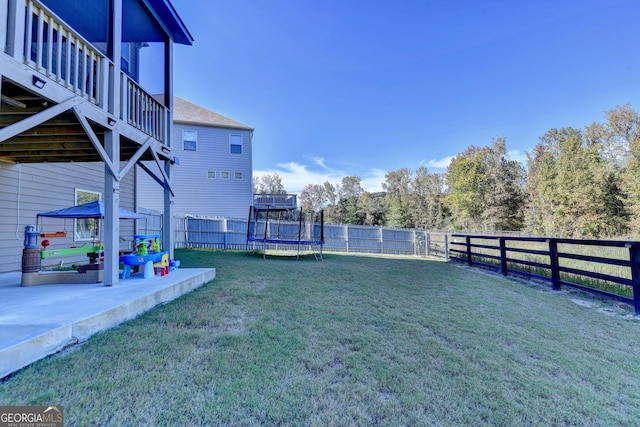 view of yard featuring a trampoline, a gazebo, and a patio