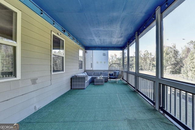 unfurnished sunroom with wood ceiling