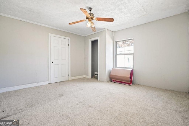 unfurnished bedroom featuring crown molding, ceiling fan, light carpet, and a textured ceiling