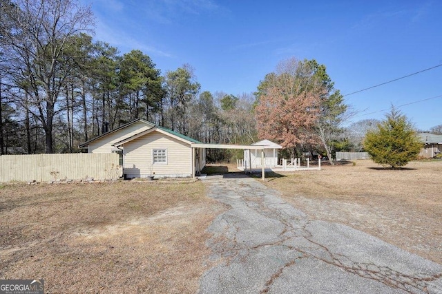 single story home featuring a carport