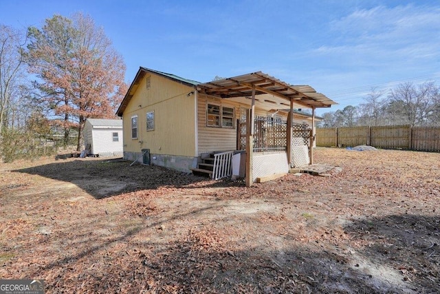 view of side of home with a storage shed