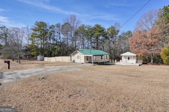 ranch-style home with a storage unit