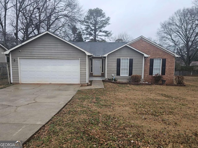 ranch-style home with a garage and a front lawn