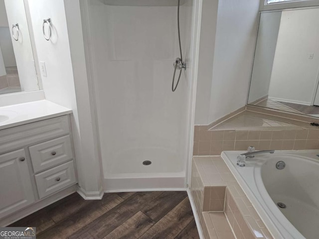 bathroom with vanity, wood-type flooring, and walk in shower