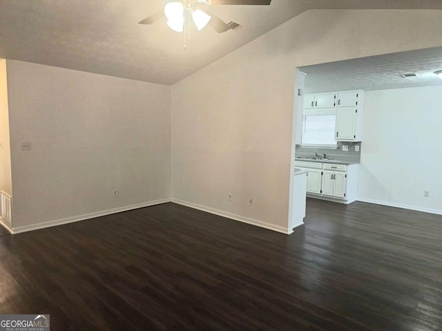 unfurnished living room featuring ceiling fan, lofted ceiling, sink, and dark hardwood / wood-style flooring