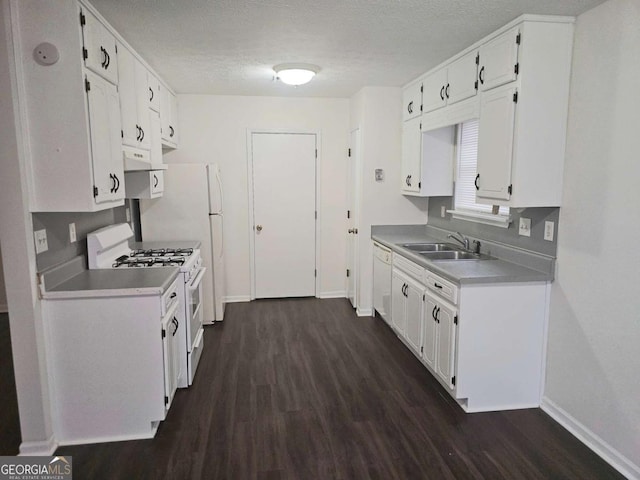 kitchen featuring dark wood-type flooring, sink, a textured ceiling, white appliances, and white cabinets