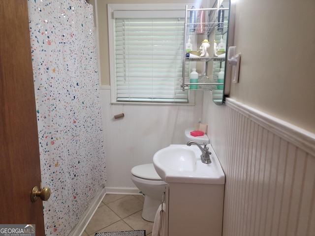 bathroom featuring walk in shower, tile patterned floors, toilet, and vanity