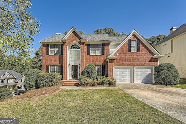 view of front of property with a garage and a front yard