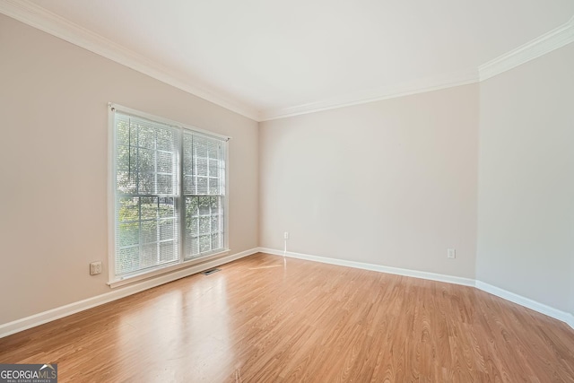 spare room with light hardwood / wood-style flooring and ornamental molding