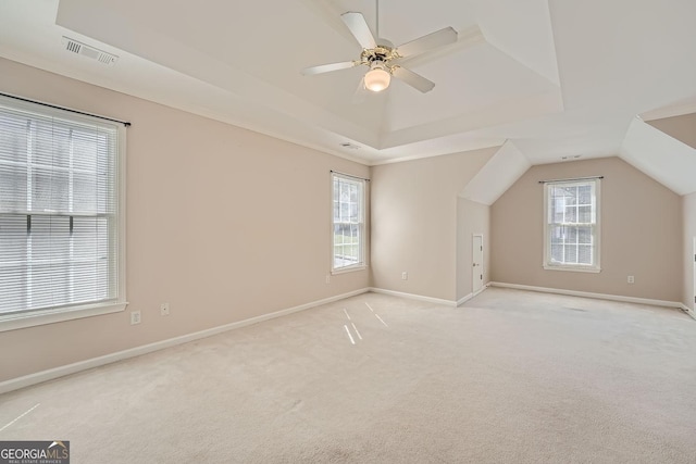 additional living space with vaulted ceiling, light colored carpet, and ceiling fan