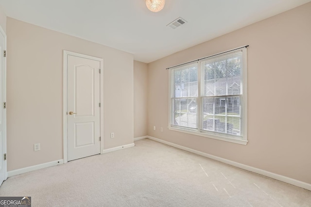 empty room featuring light carpet