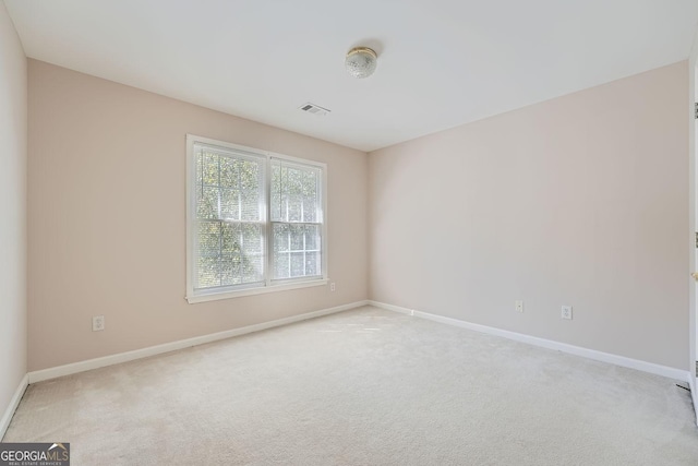 spare room with light colored carpet