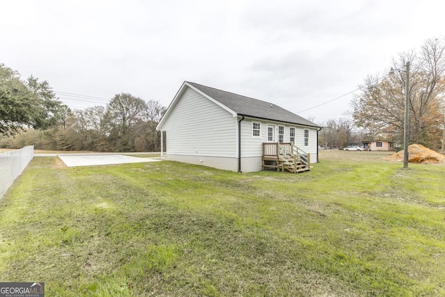 view of side of home featuring a yard