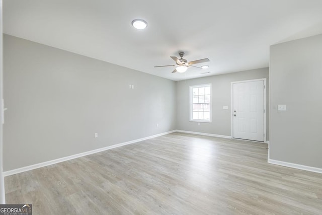 empty room with light hardwood / wood-style flooring and ceiling fan